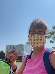 Woman-holds-up-a-baggie-of-cash