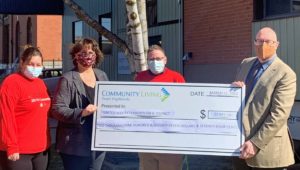 Four-people-hold-up-large-cheque-signifying-CLTH-donation-to-United-Way