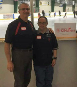 Two-Kinsmen-members-pose-together-in-front-of-a-rink